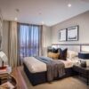 Cozy bedroom with river views, stylish decor, and natural light.