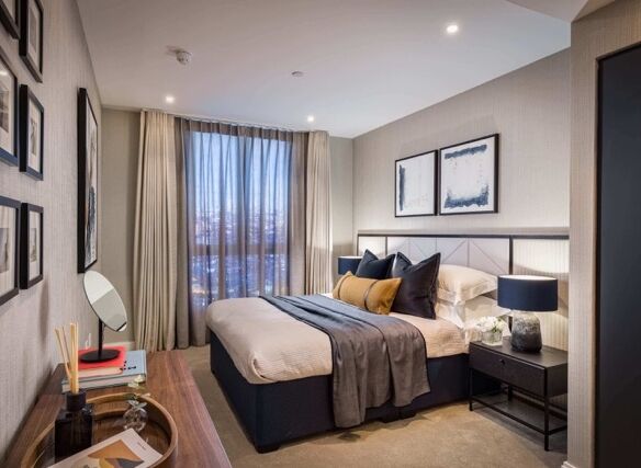 Cozy bedroom with river views, stylish decor, and natural light.