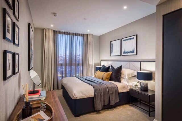 Stylish bedroom in a modern apartment with large window and cityscape view. Perfect for comfortable,.