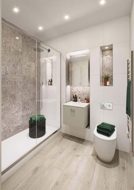 Contemporary bathroom featuring a walk-in shower, toilet, and modern fixtures in a family home.
