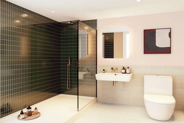 Elegant bathroom featuring a glass-enclosed shower, sleek sink, and contemporary decor in a bright,.