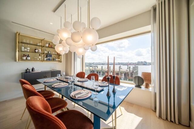 Elegant dining area with river views and modern decor. Perfect for hosting memorable meals in East L.