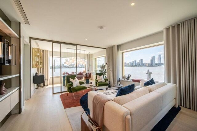 Elegant living room overlooking the river in East London. Modern furnishings and spacious design cre.