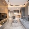 Stylish apartment interior in Mezitli Mersin featuring a cozy living room and modern open kitchen de.