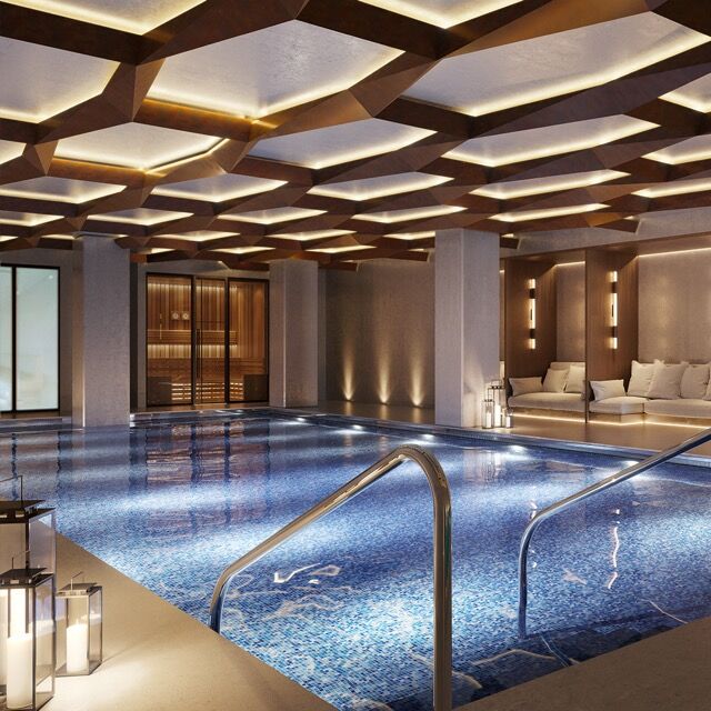 Indoor swimming pool with modern design and ambient lighting in a luxury Manchester residence.
