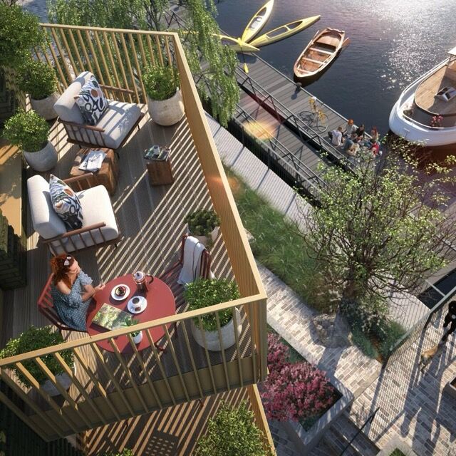 Balcony overlooking the Thames with outdoor seating and boats.