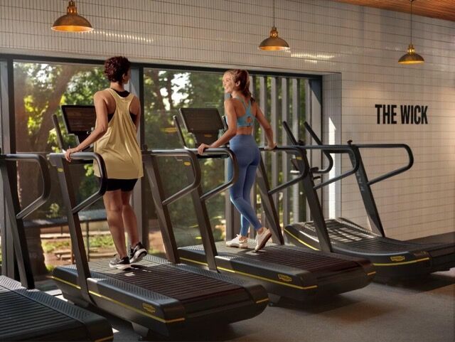Modern gym with treadmills overlooking the river in West London.