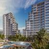 Modern high-rise apartments in Mersin with sea views, lush gardens, and swimming pools.
