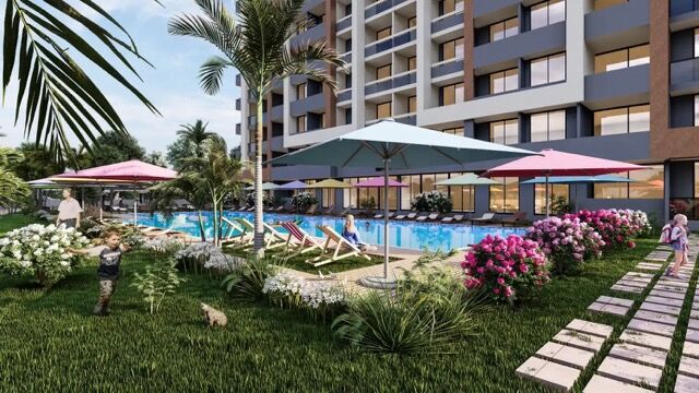 New beachside apartments in Arpacbahsis Mersin featuring a pool, gardens, and modern amenities.