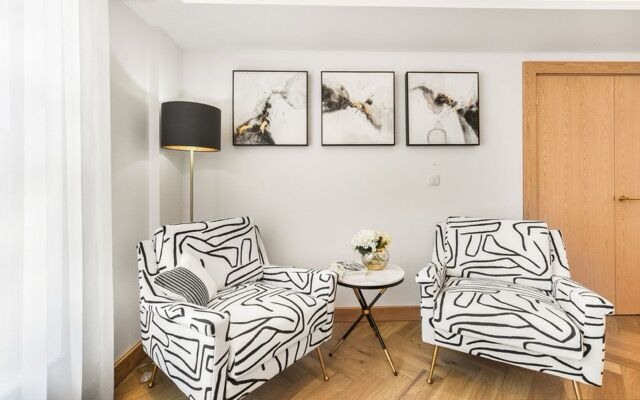Stylish living room featuring black and white patterned armchairs and modern artwork in Marylebone,.