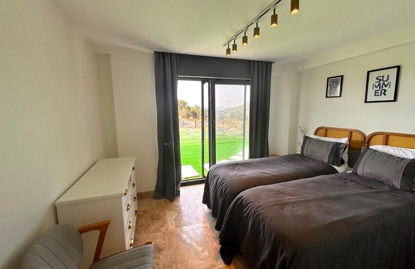 Elegant bedroom in a gated Bodrum villa with private beach access.