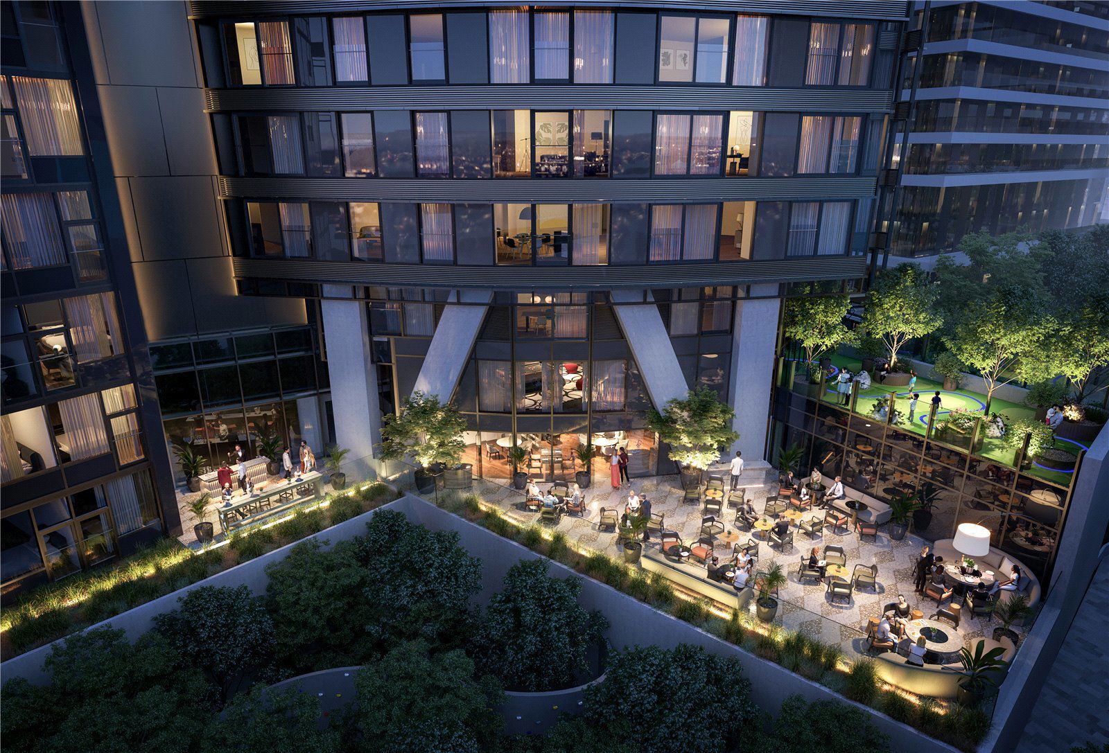 Luxury apartments with outdoor dining in Canary Wharf at night.