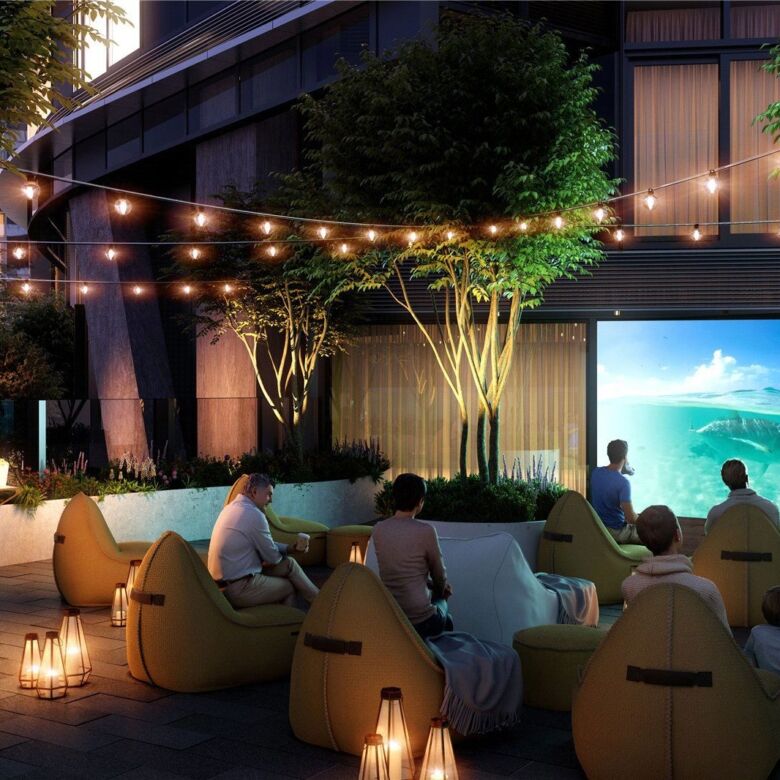 Outdoor cinema in Canary Wharf with comfortable seating and string lights.