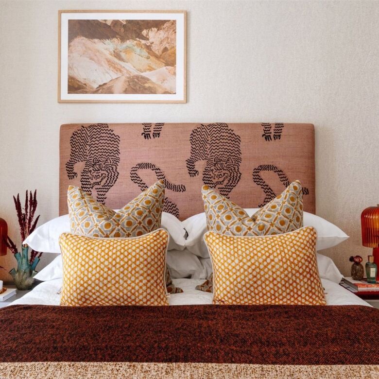 Stylish bedroom featuring a contemporary headboard with artistic silhouettes, cozy pillows, and warm.