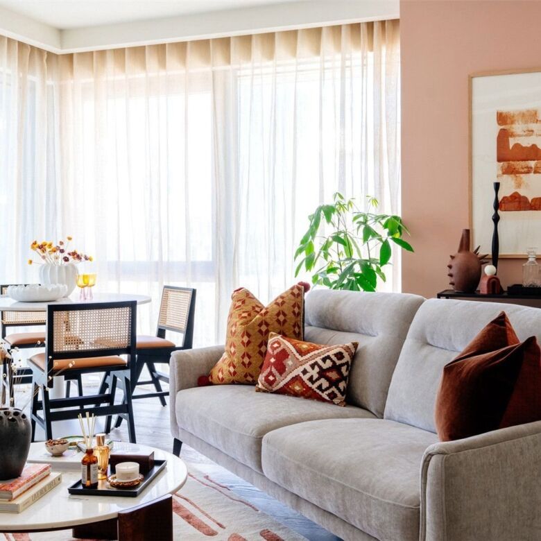 Bright and stylish living room with large windows, cozy sofa, and contemporary decor in Canary Wharf.