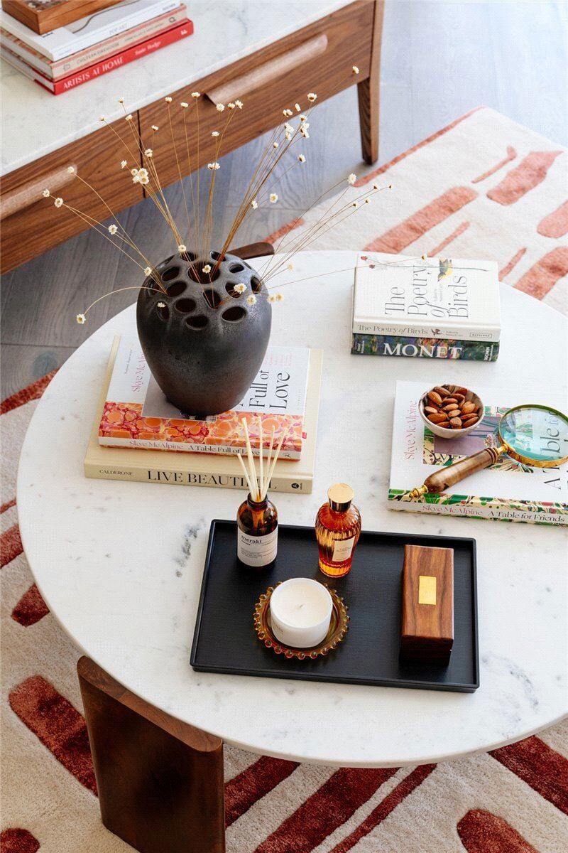 Stylish diffuser, candles, and books create a cozy, luxurious ambiance.