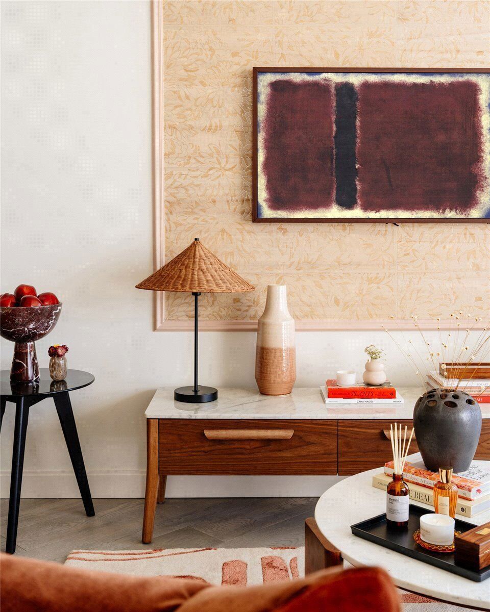 Stylish interior featuring a wooden sideboard, abstract art, and decorative accessories.