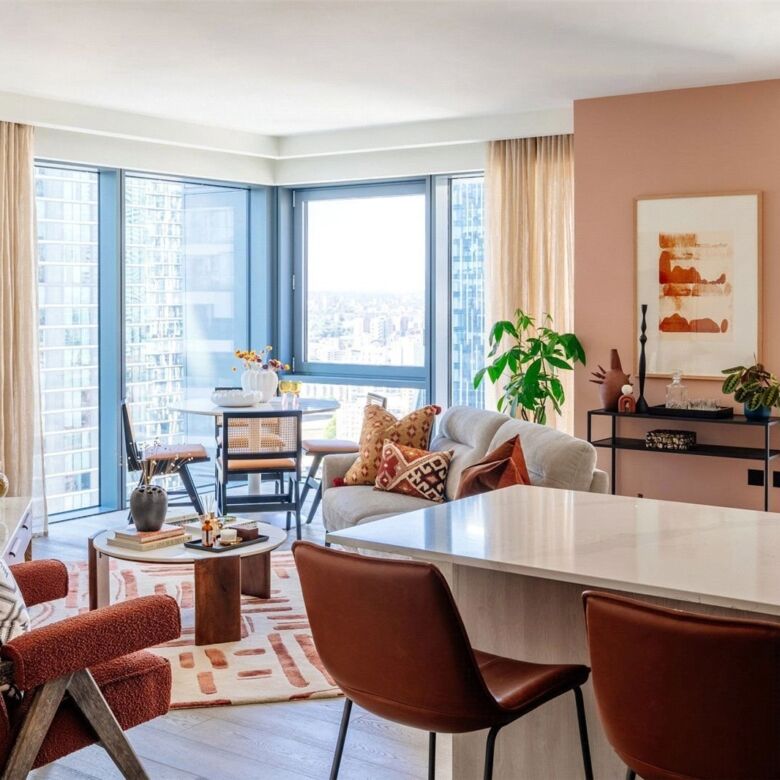 Spacious living room in Canary Wharf with large windows and contemporary decor.