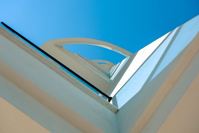 Bright view of a modern apartment window with clear blue sky.
