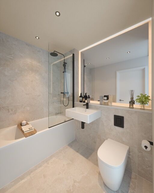 Modern bathroom with bathtub, shower, and sleek fixtures in a high-rise Manchester apartment.