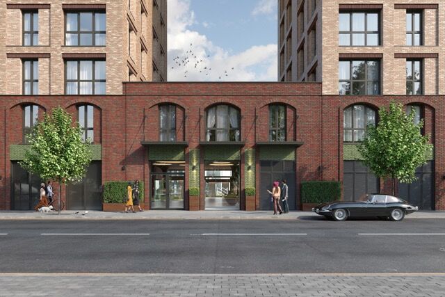 Modern brick apartment building in Manchester with street view.