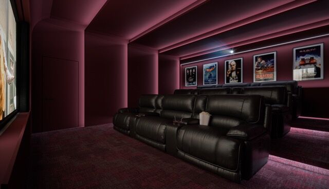 Luxurious home theater with plush seating and vibrant pink walls in Manchester apartment.