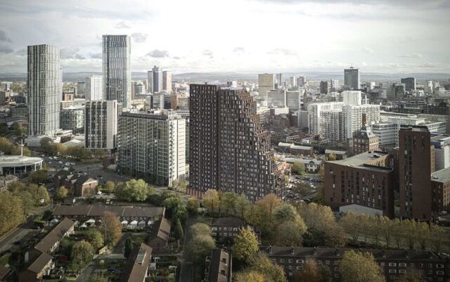 View of Manchester city skyline with high-rise apartments and office buildings.