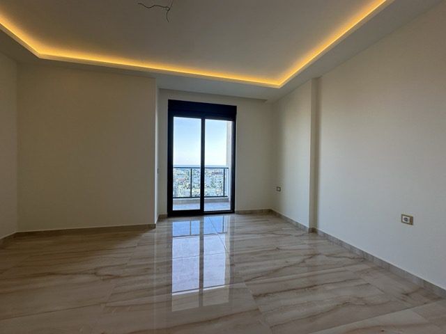 Bright living area with sea views in a modern penthouse in Guller Pınarı, Alanya.