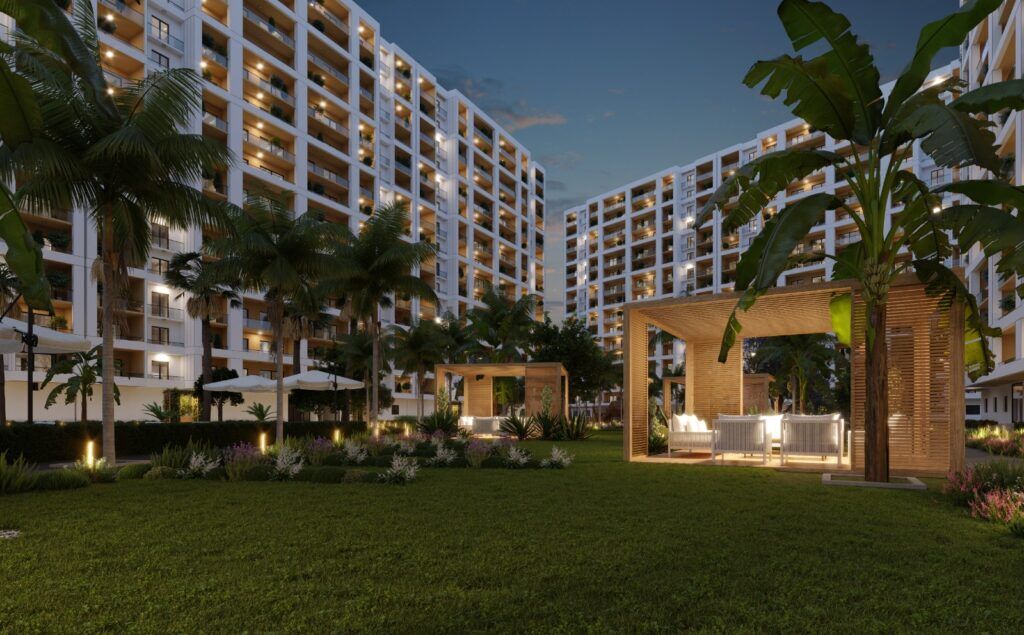 Modern residential complex with outdoor lounge area and lush landscaping in Mersin.