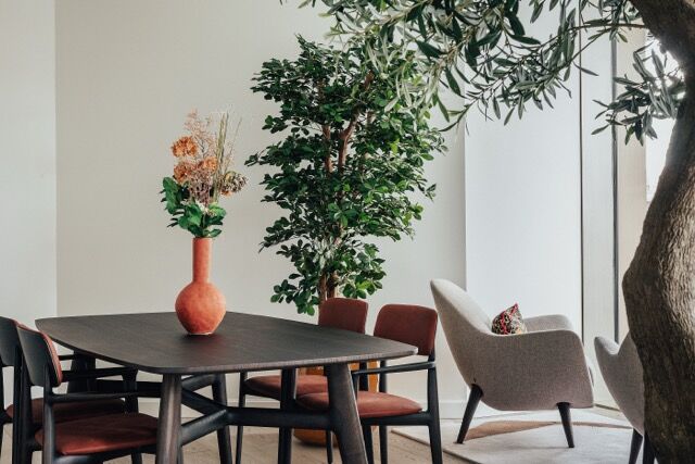 Riverside apartment interior with stylish furniture and lush greenery in One Nine Elms, London.