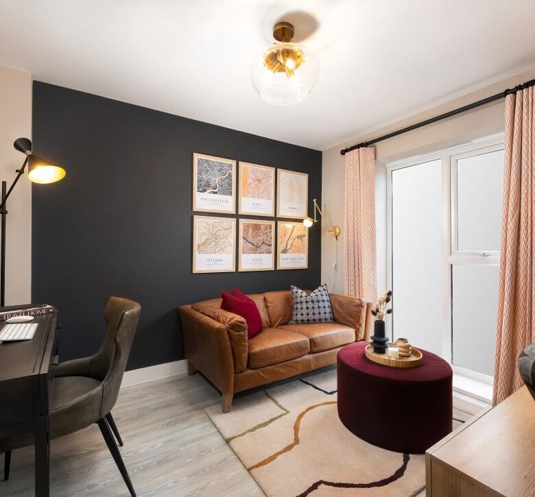 Bright living room with sofa, artwork, and balcony in a modern Cambridge home.