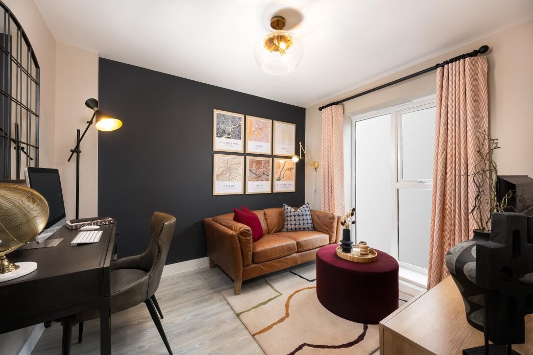 Bright living room with sofa, artwork, and balcony in a modern Cambridge home.