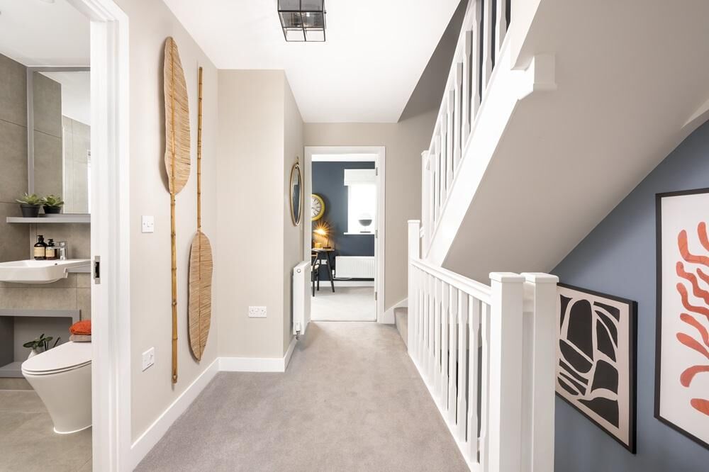 Bright hallway of a spacious 4-bedroom detached home in Cambridge with modern decor and elegant artw.
