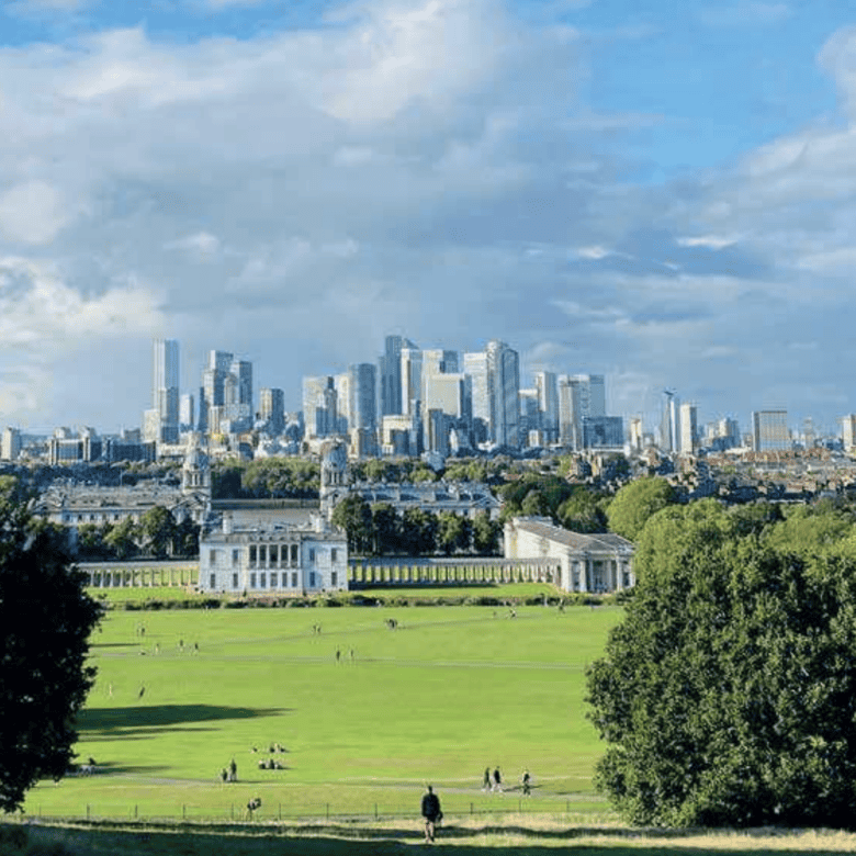 View of Greenwich Park with London city skyline in the background.