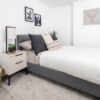 Contemporary bedroom featuring minimalist design, neutral tones, and elegant artwork.
