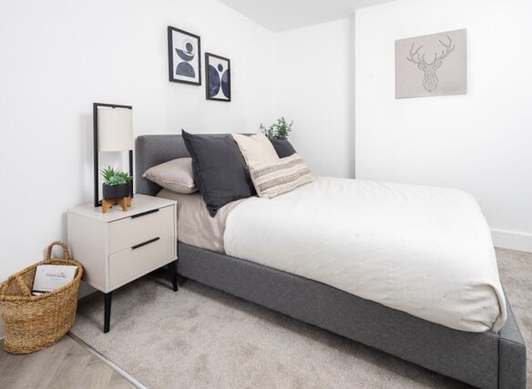 Contemporary bedroom featuring minimalist design, neutral tones, and elegant artwork.
