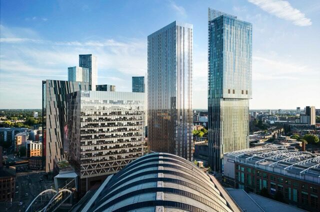 Modern high-rise apartments in Manchester city center skyline.