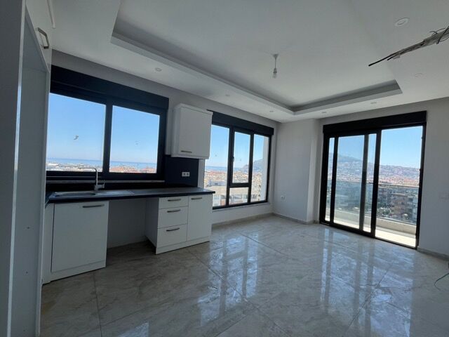 Bright modern 1-bedroom apartment in Alanya with panoramic sea views and full amenities.