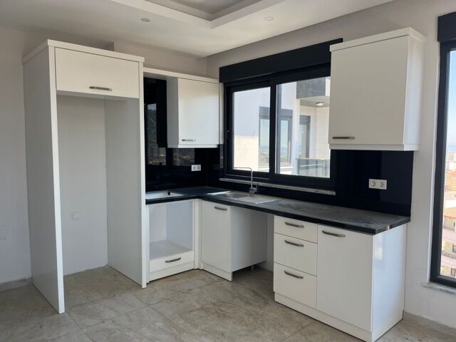 Bright kitchen with full amenities in Alanya apartment.