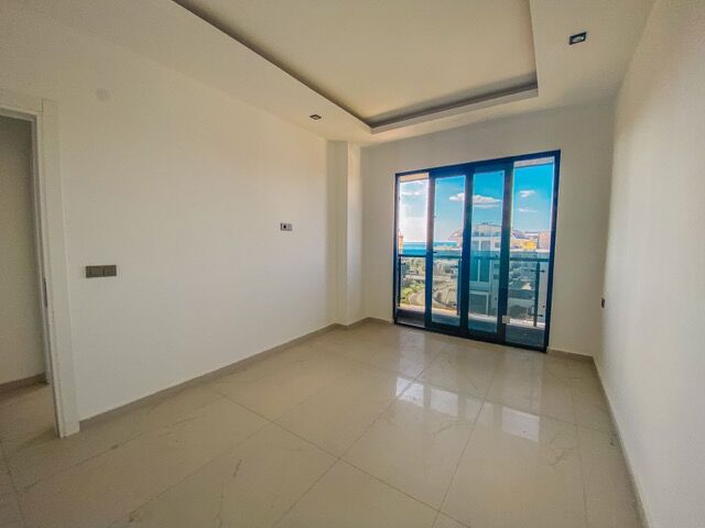 Bright living room with large glass doors and scenic views.