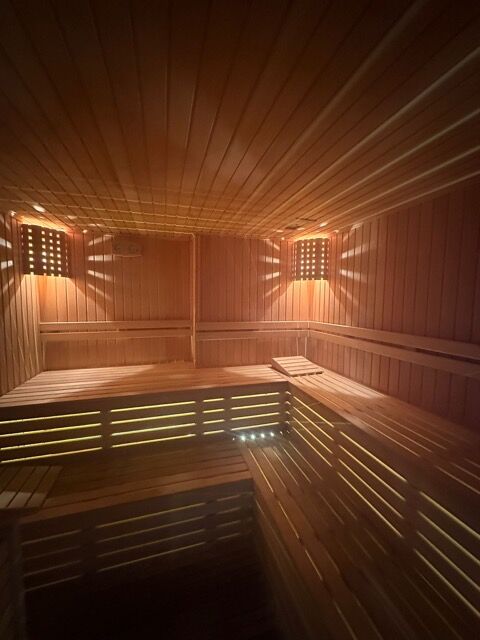 Sea view sauna in Mahmutlar, Alanya. Luxurious interior with wooden finishes and ambient lighting.