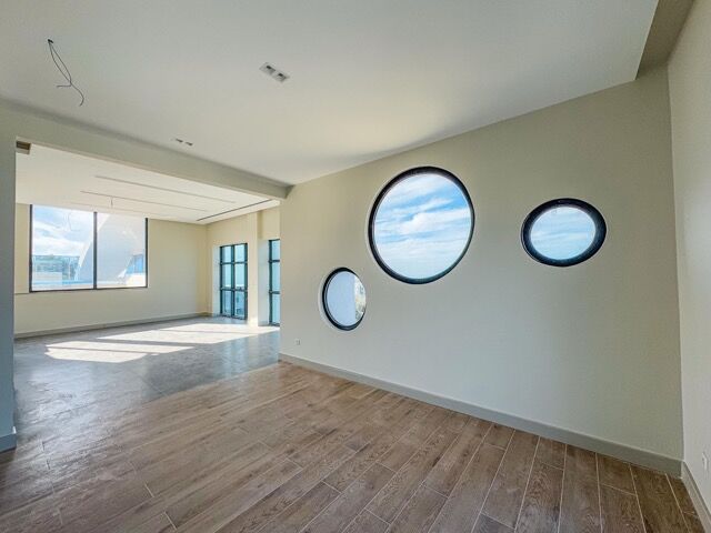 Spacious 2-bedroom penthouse with circular windows, private balcony, pool, and premium amenities in.