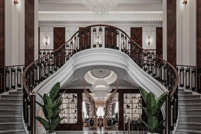 Elegant mansion staircase with grand chandelier and stylish decor.