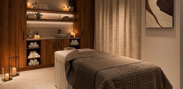 Cozy massage room with warm lighting and wooden shelves in a modern apartment.