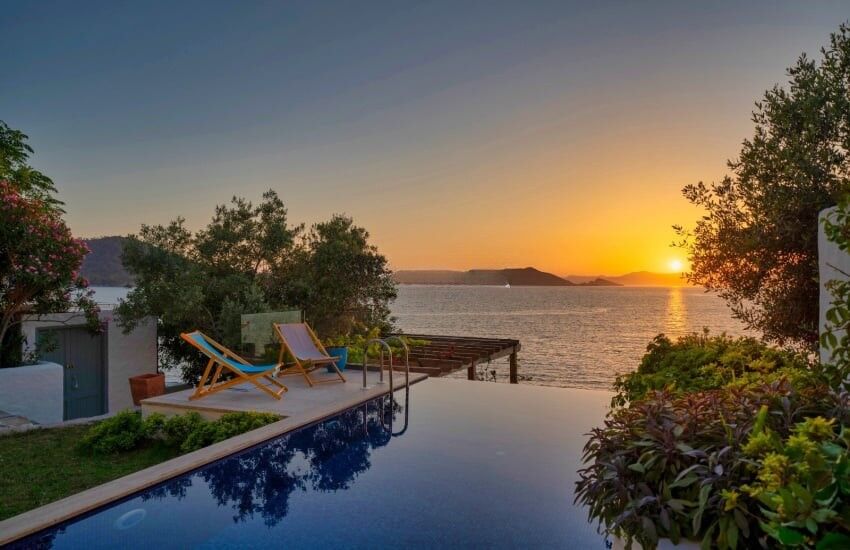 Seafront villa with private pier on Sovalye Island, Fethiye, offering stunning sunset views over the.