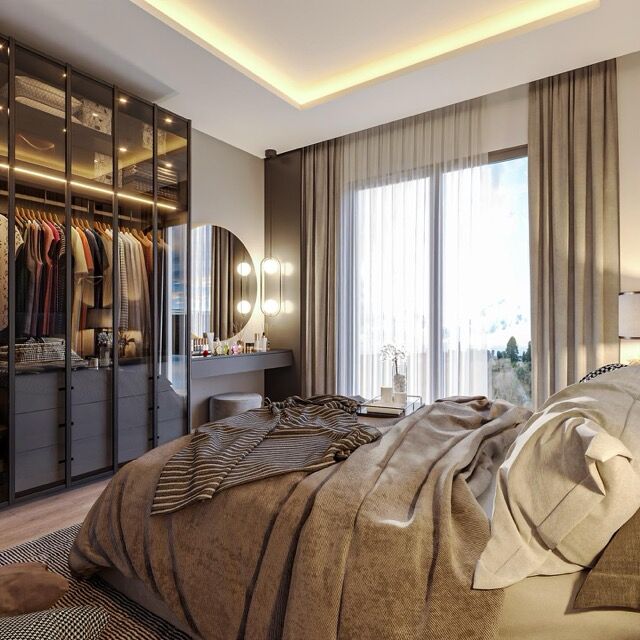 Elegant bedroom interior with ample natural light and contemporary furnishings.