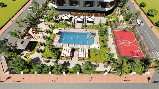 Beautiful view of a residential complex featuring a swimming pool and sports court in Mersin Tomuk.
