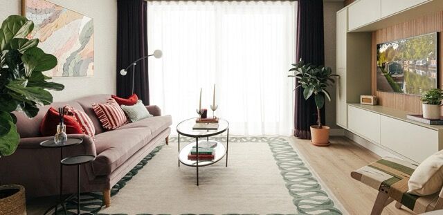 Elegant living room with modern decor, large windows, and stylish furniture in Wembley residences.