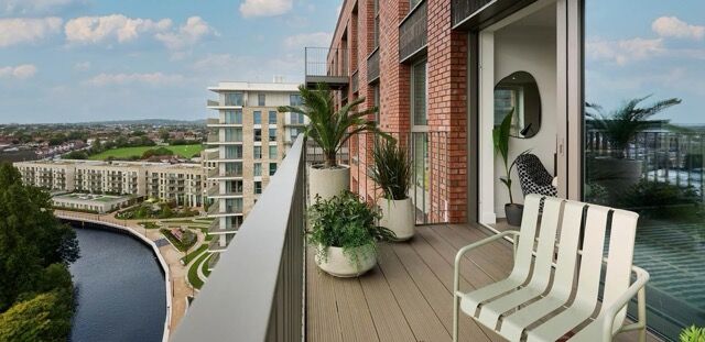 Balcony view of Wembley waterside apartments with outdoor seating and lush plants.