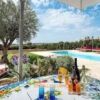 Beautiful outdoor dining area with pool and garden views in Ragusa.